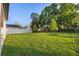 Lush backyard with healthy green lawn, privacy fence, and mature trees offering shade and beauty at 3608 Dubsdread Cir, Orlando, FL 32804