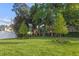 Well-maintained backyard featuring vibrant greenery and mature trees, perfect for outdoor activities and relaxation at 3608 Dubsdread Cir, Orlando, FL 32804