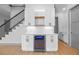 Modern bar area featuring white cabinets, a wine cooler, and floating shelves at 3608 Dubsdread Cir, Orlando, FL 32804