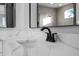 Close-up of a bathroom vanity with white countertop and black faucet at 3608 Dubsdread Cir, Orlando, FL 32804