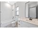 Bright bathroom with white vanity, modern mirror, and patterned floor tiles at 3608 Dubsdread Cir, Orlando, FL 32804
