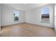 This is a bedroom with hardwood floors and multiple windows providing natural light at 3608 Dubsdread Cir, Orlando, FL 32804