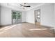 Bright bedroom featuring hardwood floors, fan, and a set of french doors leading to the balcony at 3608 Dubsdread Cir, Orlando, FL 32804