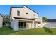 Modern home showcasing a second-story balcony, sliding glass doors to patio, and a well-kept lawn at 3608 Dubsdread Cir, Orlando, FL 32804