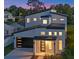 Exterior view of a two-story home at dusk, showcasing modern architecture and design at 3608 Dubsdread Cir, Orlando, FL 32804