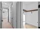 Hallway featuring hardwood floors, access to a closet and natural light from the connecting rooms at 3608 Dubsdread Cir, Orlando, FL 32804