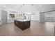 Bright, modern kitchen featuring a large island, white cabinetry, and seamless transition to the living area at 3608 Dubsdread Cir, Orlando, FL 32804