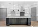Close-up of a kitchen island with a white countertop and dark wood cabinets, complemented by pendant lighting at 3608 Dubsdread Cir, Orlando, FL 32804