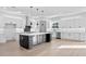 Spacious kitchen featuring a large island, stainless steel appliances, and white cabinets at 3608 Dubsdread Cir, Orlando, FL 32804