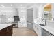 Spacious kitchen featuring an island, stainless appliances, and white cabinetry at 3608 Dubsdread Cir, Orlando, FL 32804