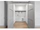 Bright laundry room with gray trim, hardwood floors, and convenient washer and dryer hookups at 3608 Dubsdread Cir, Orlando, FL 32804