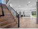 Open-concept living area with wood floors, staircase, and modern kitchen at 3608 Dubsdread Cir, Orlando, FL 32804