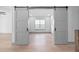 Open sliding barn doors leading to a spacious living room at 3608 Dubsdread Cir, Orlando, FL 32804