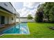 Backyard featuring a modern pool, well-maintained lawn, and a charming two-story residence at 3608 Dubsdread Cir, Orlando, FL 32804