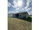 A sprawling green backyard with rear exterior, featuring a lush lawn and ample space for outdoor activities at 4278 Sagefield Dr, St Cloud, FL 34773