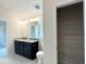 Bathroom with granite countertops, double vanity, and access to walk-in closet for convenience at 4278 Sagefield Dr, St Cloud, FL 34773