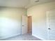 Neutral bedroom with an open door that provides access to another room and a closet at 4278 Sagefield Dr, St Cloud, FL 34773