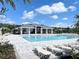 A resort-style community pool features ample lounge chairs, a covered pavilion, and lush landscaping at 4278 Sagefield Dr, St Cloud, FL 34773