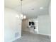 Open-concept dining area with views of a modern kitchen and contemporary lighting at 4278 Sagefield Dr, St Cloud, FL 34773