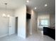 Bright entryway featuring modern lighting, tile flooring, and an open doorway to the main living area at 4278 Sagefield Dr, St Cloud, FL 34773