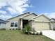 Well-maintained exterior with a lush lawn, stone details, and a two-car garage at 4278 Sagefield Dr, St Cloud, FL 34773