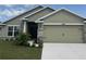 Charming home featuring a two-car garage, manicured lawn, and stone accents at 4278 Sagefield Dr, St Cloud, FL 34773