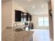 Modern kitchen featuring granite countertops, black cabinets, and stainless steel appliances at 4278 Sagefield Dr, St Cloud, FL 34773