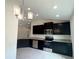 Well-equipped kitchen with stainless steel appliances, granite countertops, and dark cabinetry at 4278 Sagefield Dr, St Cloud, FL 34773