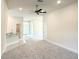 Open living room with a ceiling fan, breakfast bar, and access to front door at 4278 Sagefield Dr, St Cloud, FL 34773