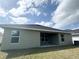 Back of the property with an open patio and large windows overlooking the spacious backyard at 4278 Sagefield Dr, St Cloud, FL 34773