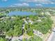 Aerial view of the property outlined in yellow, near a lake and surrounded by dense trees at 430 S Dollins Ave, Orlando, FL 32805