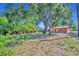 Large backyard with mature trees around a single-story home at 430 S Dollins Ave, Orlando, FL 32805