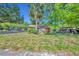 Charming single-story home on a sunny day surrounded by lush greenery and a palm tree at 430 S Dollins Ave, Orlando, FL 32805