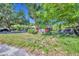 Charming single-story home on a sunny day surrounded by lush greenery and a palm tree at 430 S Dollins Ave, Orlando, FL 32805
