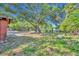 Large yard with mature trees surrounding a single-story home in a neighborhood at 430 S Dollins Ave, Orlando, FL 32805