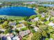 Aerial view of property surrounded by lush greenery, situated near a large, scenic lake at 505 Lake Shore Dr, Maitland, FL 32751