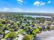 A panoramic aerial view of a lakefront neighborhood with lush greenery under a sunny, partly cloudy sky at 505 Lake Shore Dr, Maitland, FL 32751