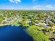 A stunning aerial panorama of a lakeside neighborhood dotted with green trees and tranquil water views at 505 Lake Shore Dr, Maitland, FL 32751