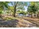 Backyard view featuring mature trees and freshly manicured lawn at 505 Lake Shore Dr, Maitland, FL 32751
