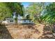 A lush, expansive backyard featuring mature trees and well-maintained landscaping at 505 Lake Shore Dr, Maitland, FL 32751