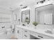 Bright bathroom features dual sinks, modern fixtures, and decorative plants at 505 Lake Shore Dr, Maitland, FL 32751