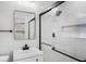 Modern bathroom with sleek glass enclosed shower, matte black fixtures and white vanity at 505 Lake Shore Dr, Maitland, FL 32751