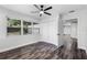 Bedroom with ceiling fan, closet and view to the kitchen featuring stylish wood-look flooring at 505 Lake Shore Dr, Maitland, FL 32751