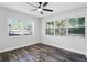 Bright bedroom featuring lots of natural light, ceiling fan, and stylish wood-look flooring at 505 Lake Shore Dr, Maitland, FL 32751