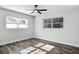 Bright bedroom featuring lots of natural light, ceiling fan, and stylish wood-look flooring at 505 Lake Shore Dr, Maitland, FL 32751