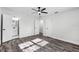 Bedroom with ceiling fan, closets and a view to the bathroom featuring stylish wood-look flooring at 505 Lake Shore Dr, Maitland, FL 32751