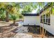 Exterior view of the backyard with a seating area and manicured landscaping at 505 Lake Shore Dr, Maitland, FL 32751