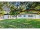 Beautiful single-story home with a well-manicured lawn and mature trees offering curb appeal at 505 Lake Shore Dr, Maitland, FL 32751