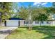 Charming single-story home with a well-manicured lawn and mature trees offering curb appeal at 505 Lake Shore Dr, Maitland, FL 32751