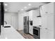 Modern kitchen featuring stainless steel appliances and a spacious quartz countertop at 505 Lake Shore Dr, Maitland, FL 32751